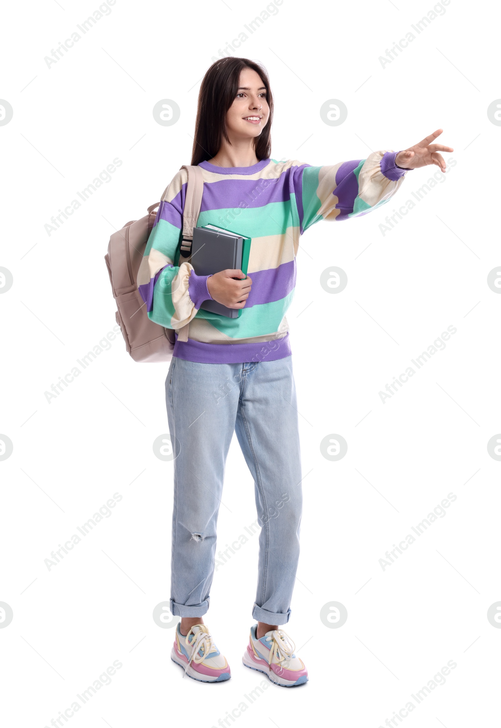 Photo of Cute teenage girl with backpack and books on white background