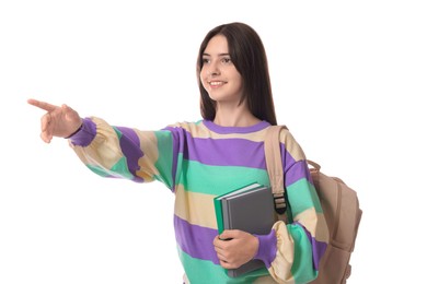 Cute teenage girl with backpack and books on white background