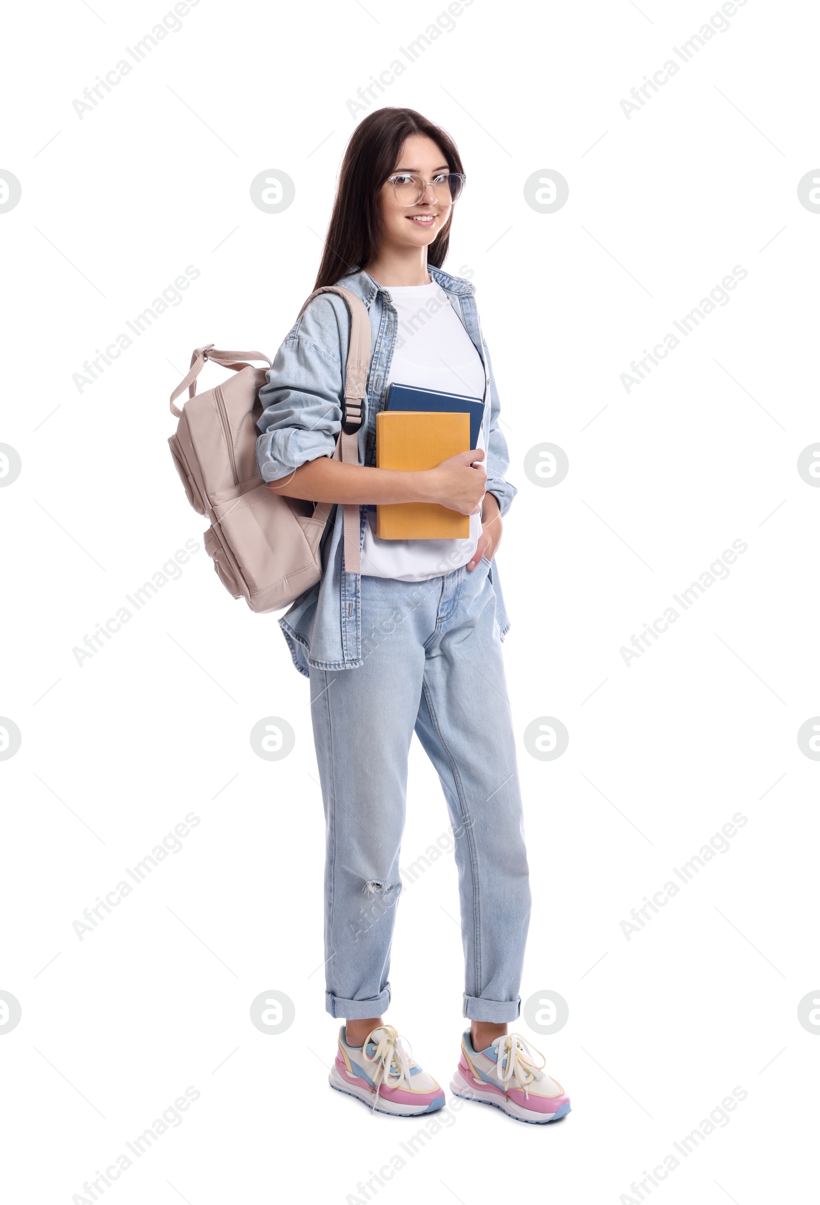 Photo of Smiling teenage girl with backpack and books on white background