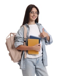 Portrait of teenage girl with backpack and books showing thumbs up on white background