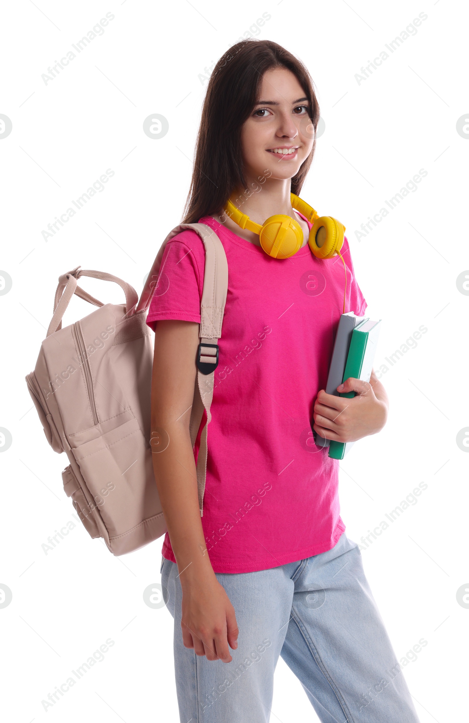 Photo of Portrait of smiling teenage girl with backpack and books on white background