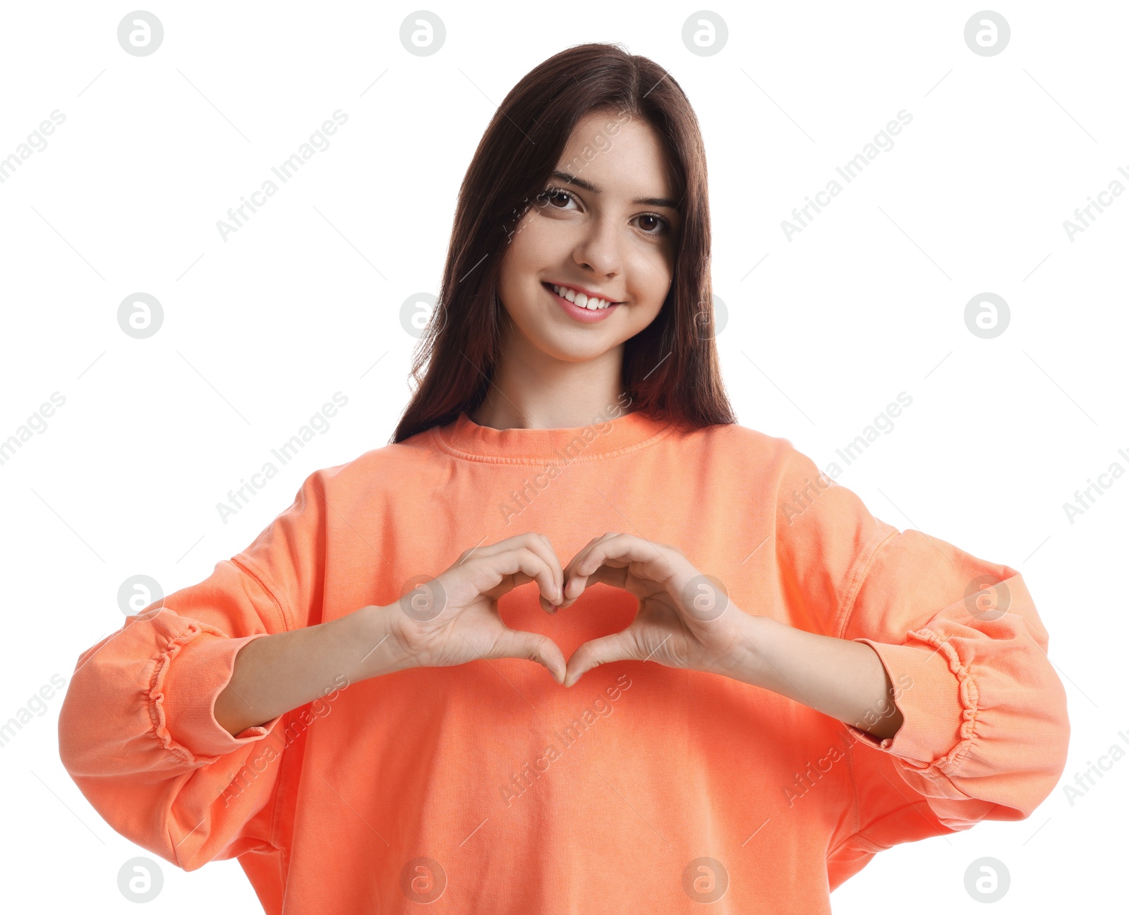 Photo of Teenage girl making heart of hands on white background