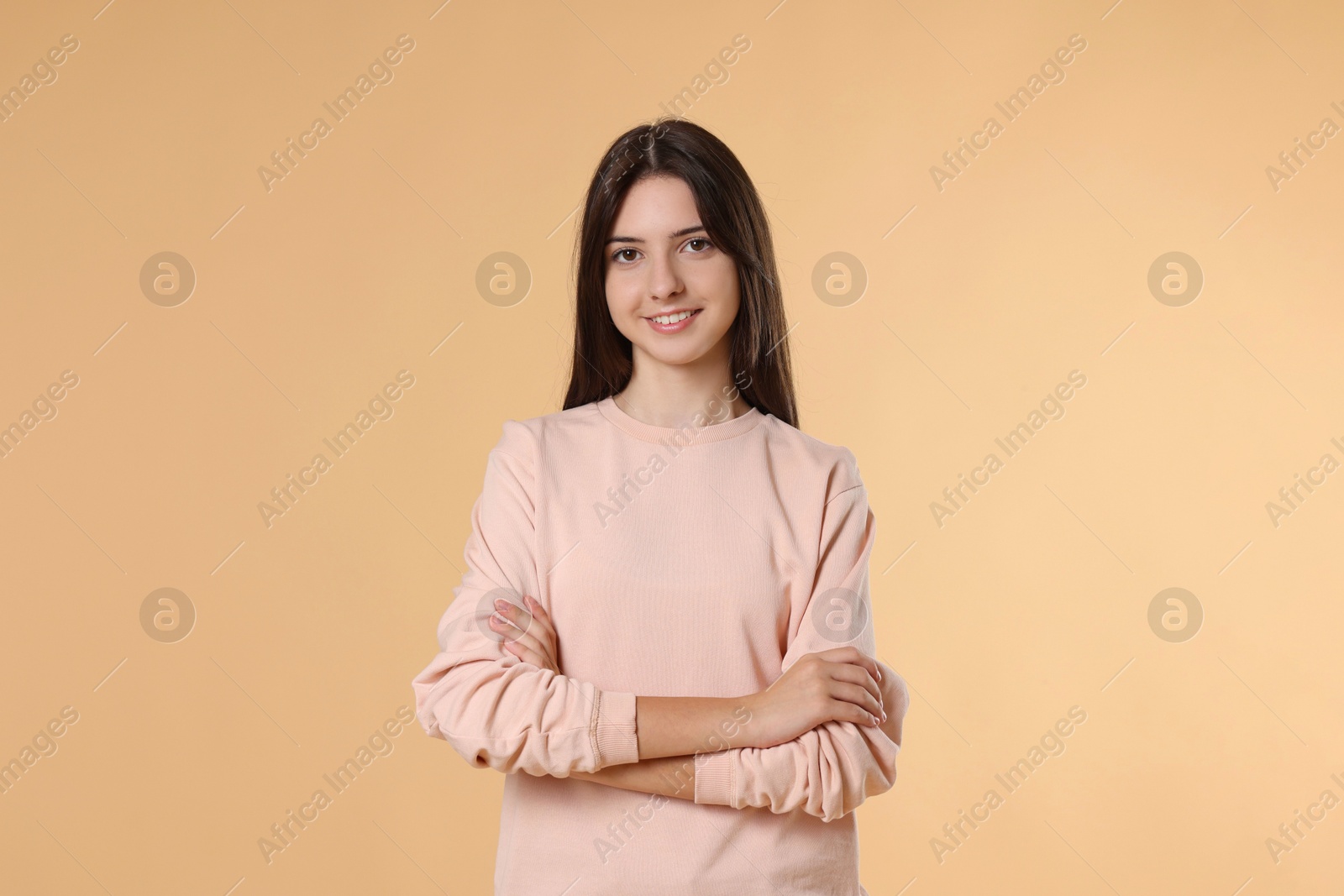 Photo of Portrait of cute teenage girl on beige background