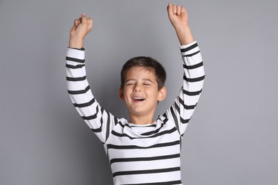 Photo of Portrait of cute little boy on grey background