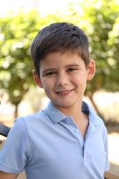 Photo of Portrait of little boy outdoors. Cute child