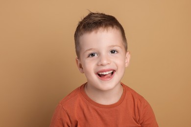 Photo of Portrait of cute little boy on pale background