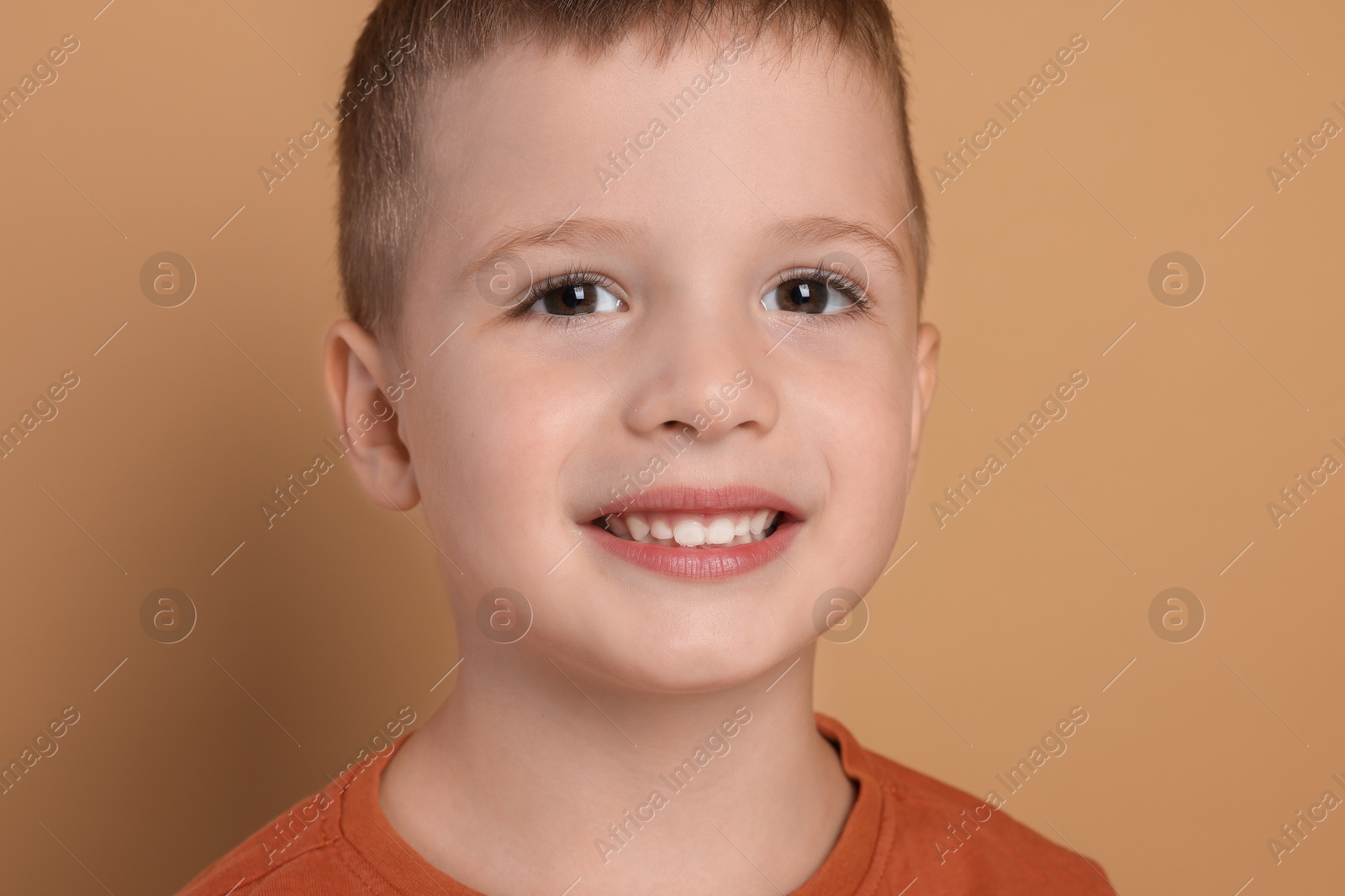 Photo of Portrait of cute little boy on pale background