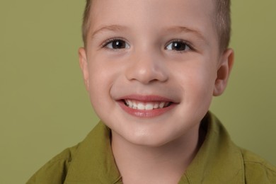 Portrait of cute little boy on green background