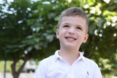 Photo of Portrait of little boy outdoors. Cute child