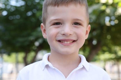 Photo of Portrait of little boy outdoors. Cute child