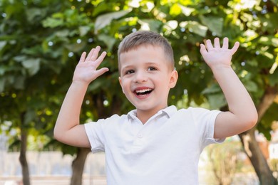 Photo of Portrait of little boy outdoors. Cute child