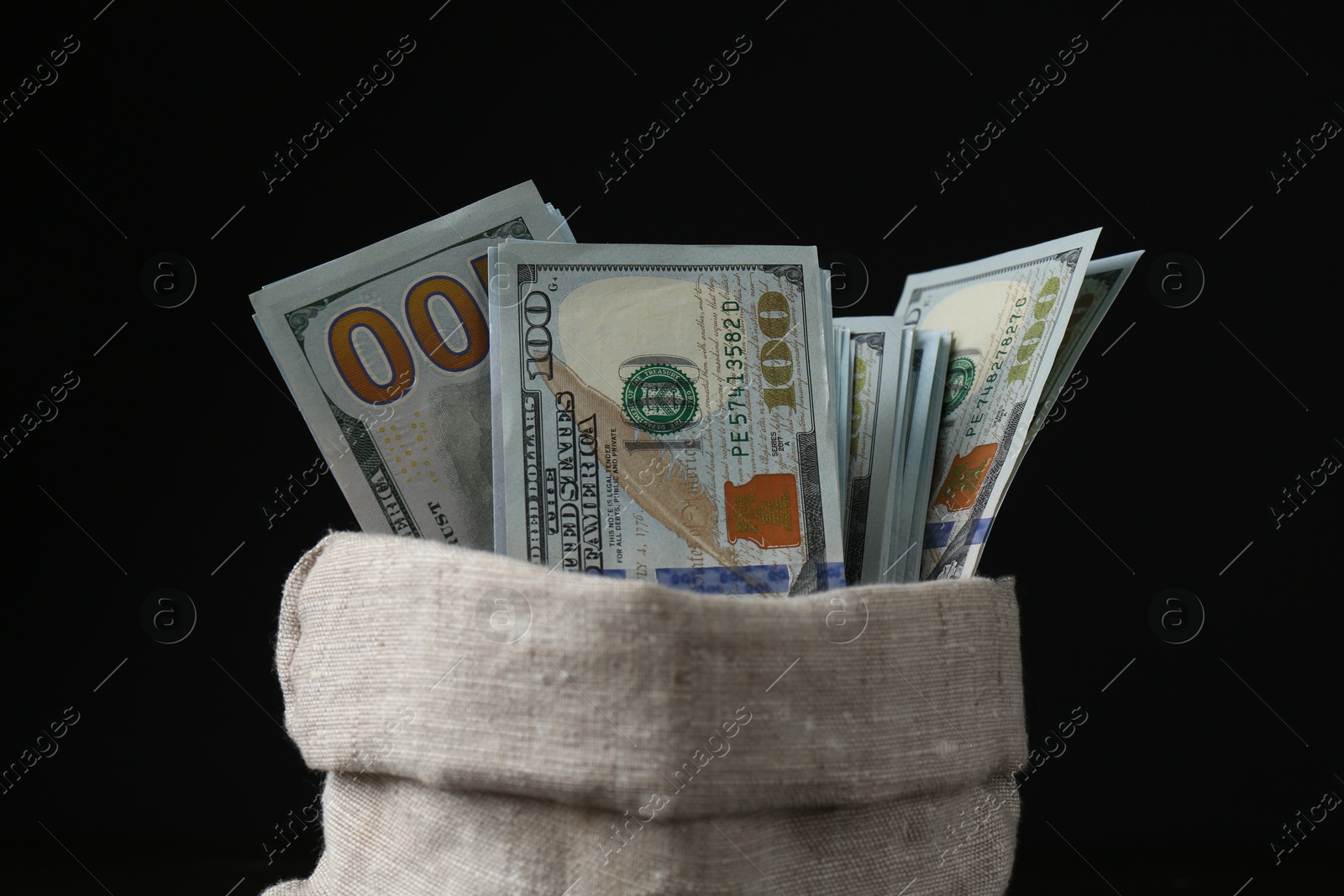 Photo of Dollar banknotes in sack against black background