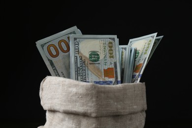 Photo of Dollar banknotes in sack against black background