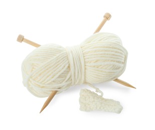 Photo of Skein of soft yarn with knitting needles and pattern sample isolated on white