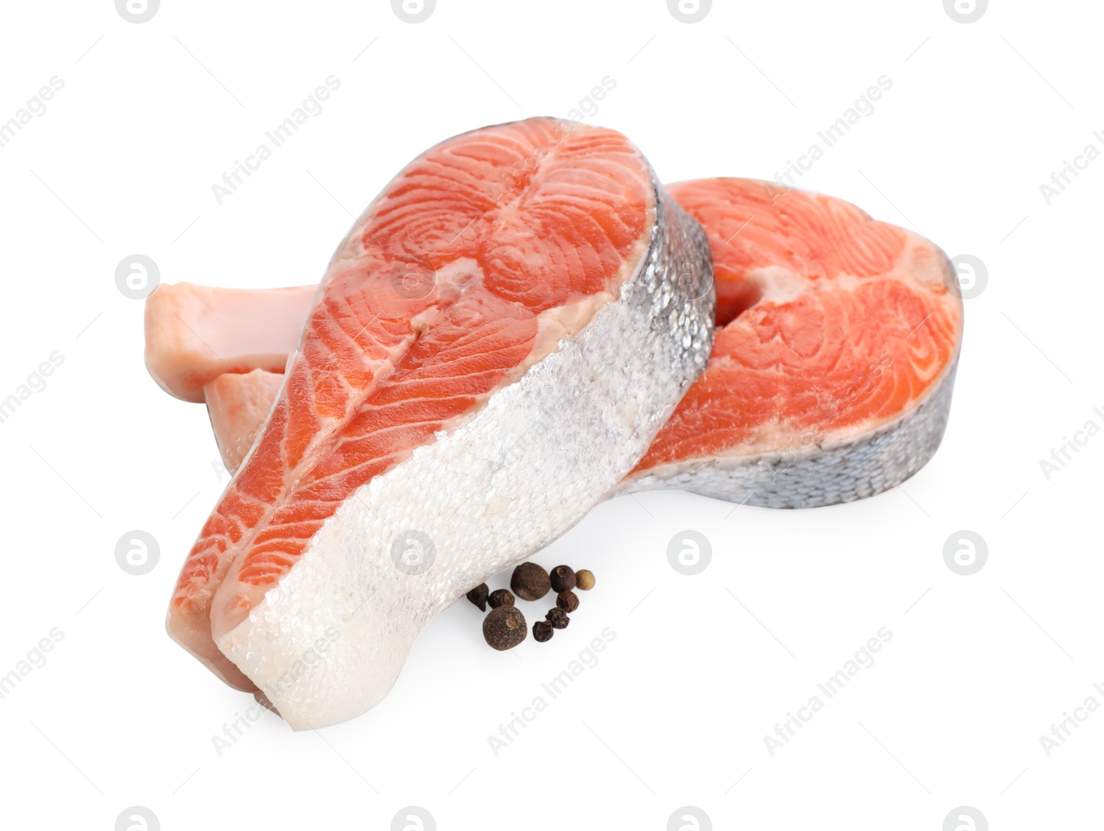 Photo of Two fresh salmon steaks and peppercorns isolated on white