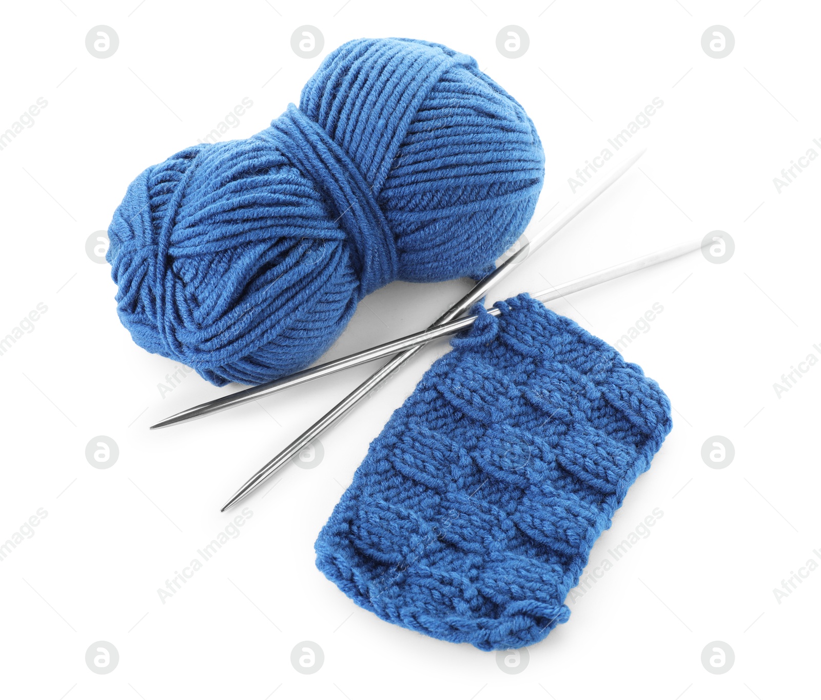 Photo of Skein of blue yarn, knitted fabric and needles isolated on white