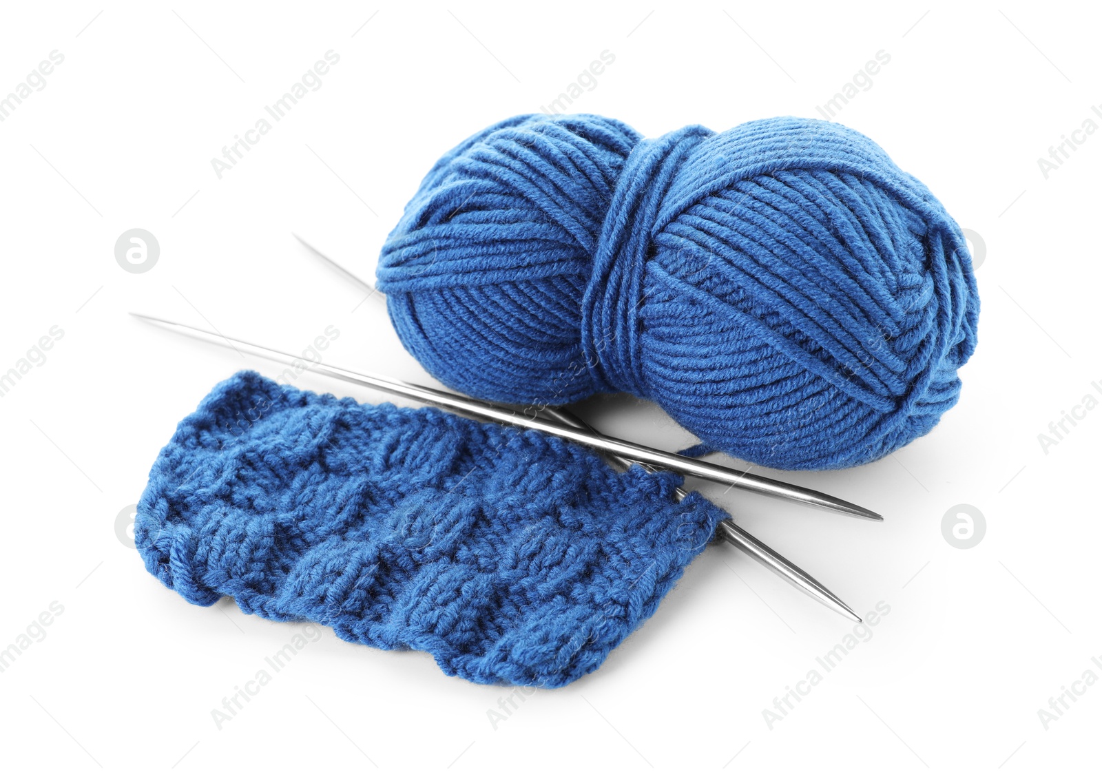 Photo of Skein of blue yarn, knitted fabric and needles isolated on white