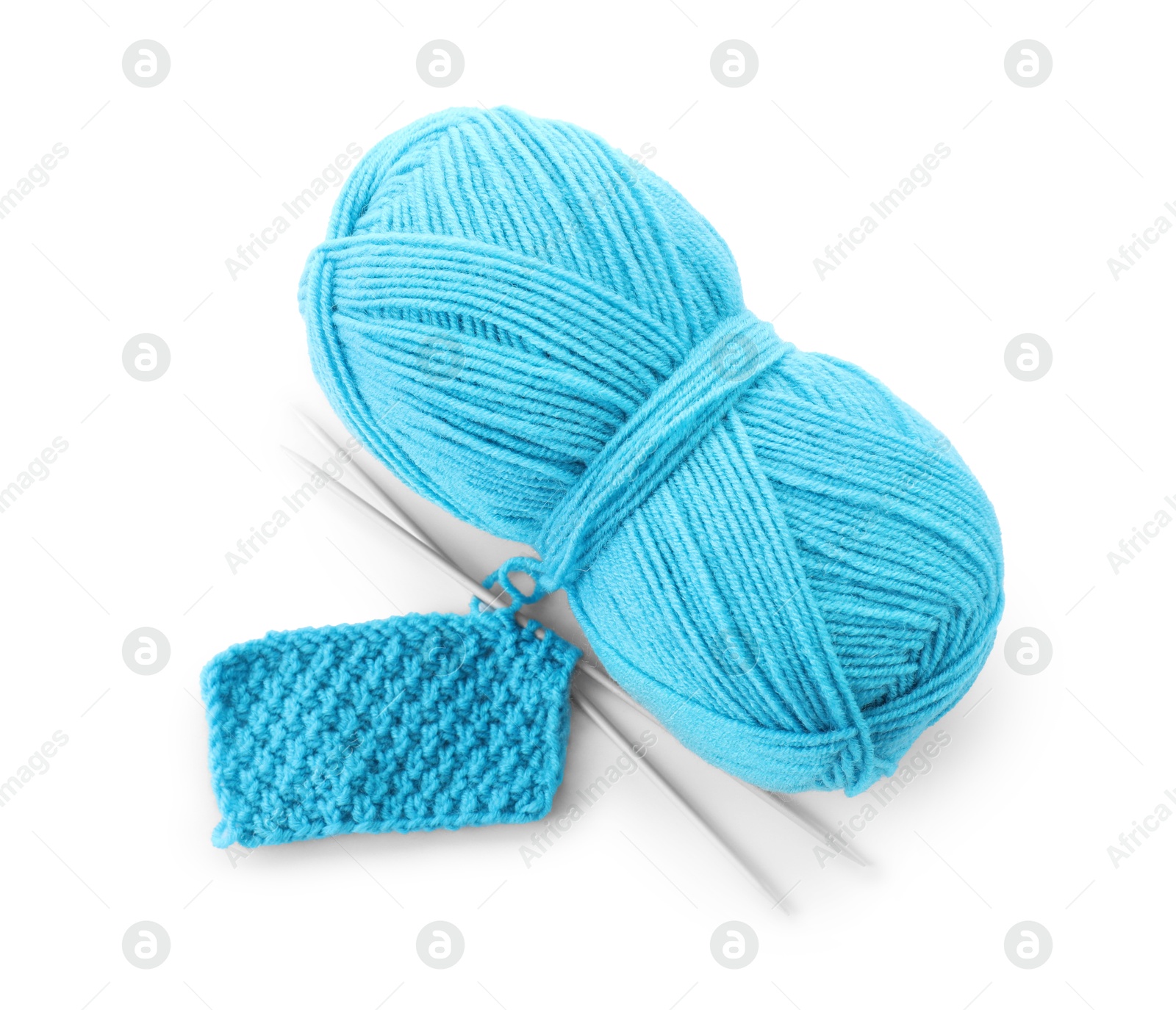 Photo of Skein of light blue yarn, knitted fabric and needles isolated on white, top view