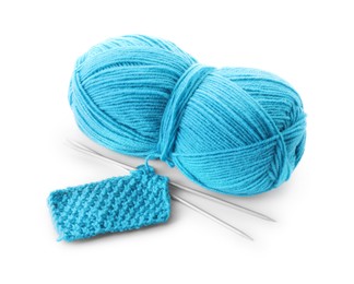 Photo of Skein of light blue yarn, knitted fabric and needles isolated on white