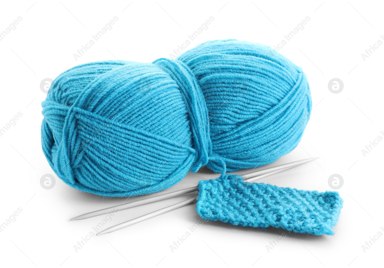 Photo of Skein of light blue yarn, knitted fabric and needles isolated on white