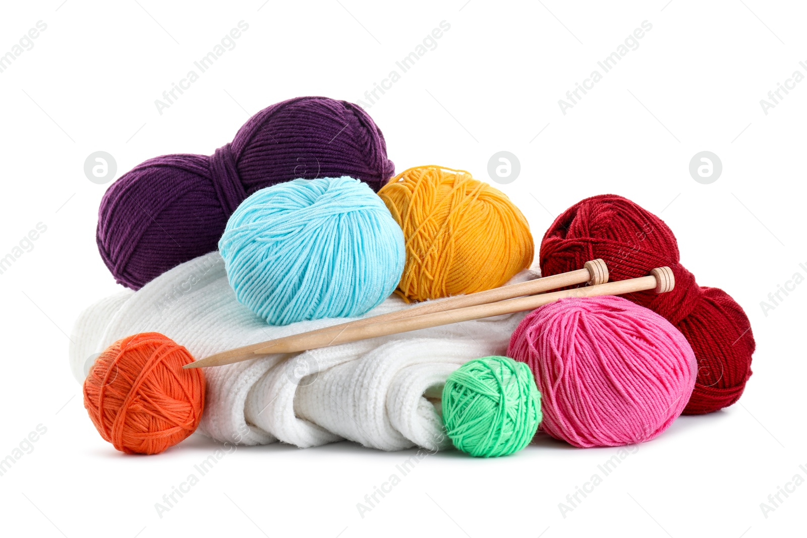 Photo of Different yarns, knitting needles and sweater isolated on white