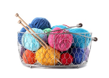 Metal basket with bright yarns and knitting needles isolated on white