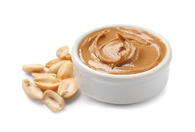 Photo of Tasty peanut butter in bowl and groundnuts isolated on white