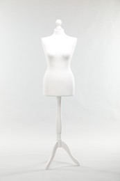 Photo of One female mannequin on stand against light background