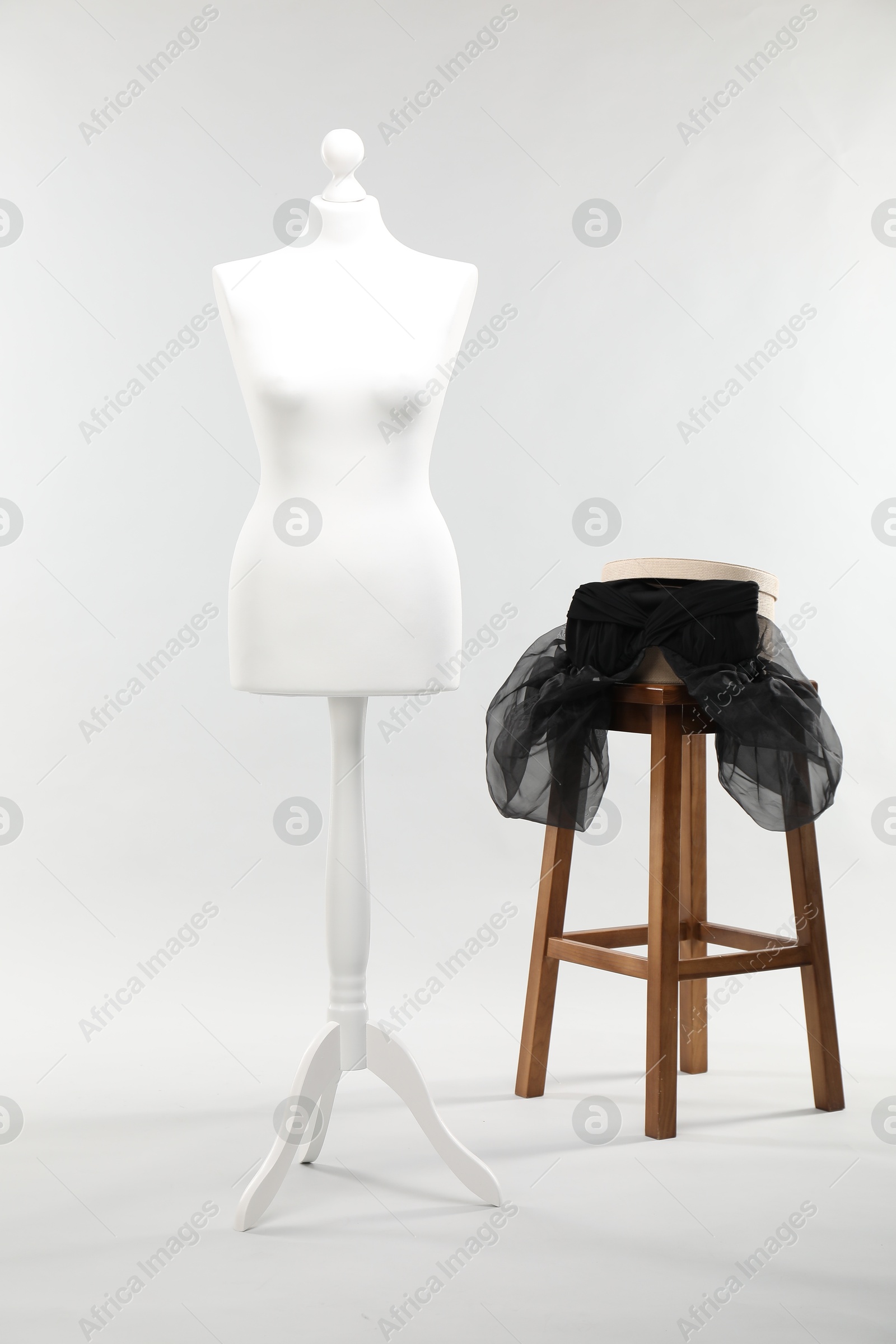 Photo of One female mannequin, stool and box on light background