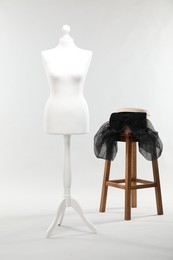 Photo of One female mannequin, stool and box on light background