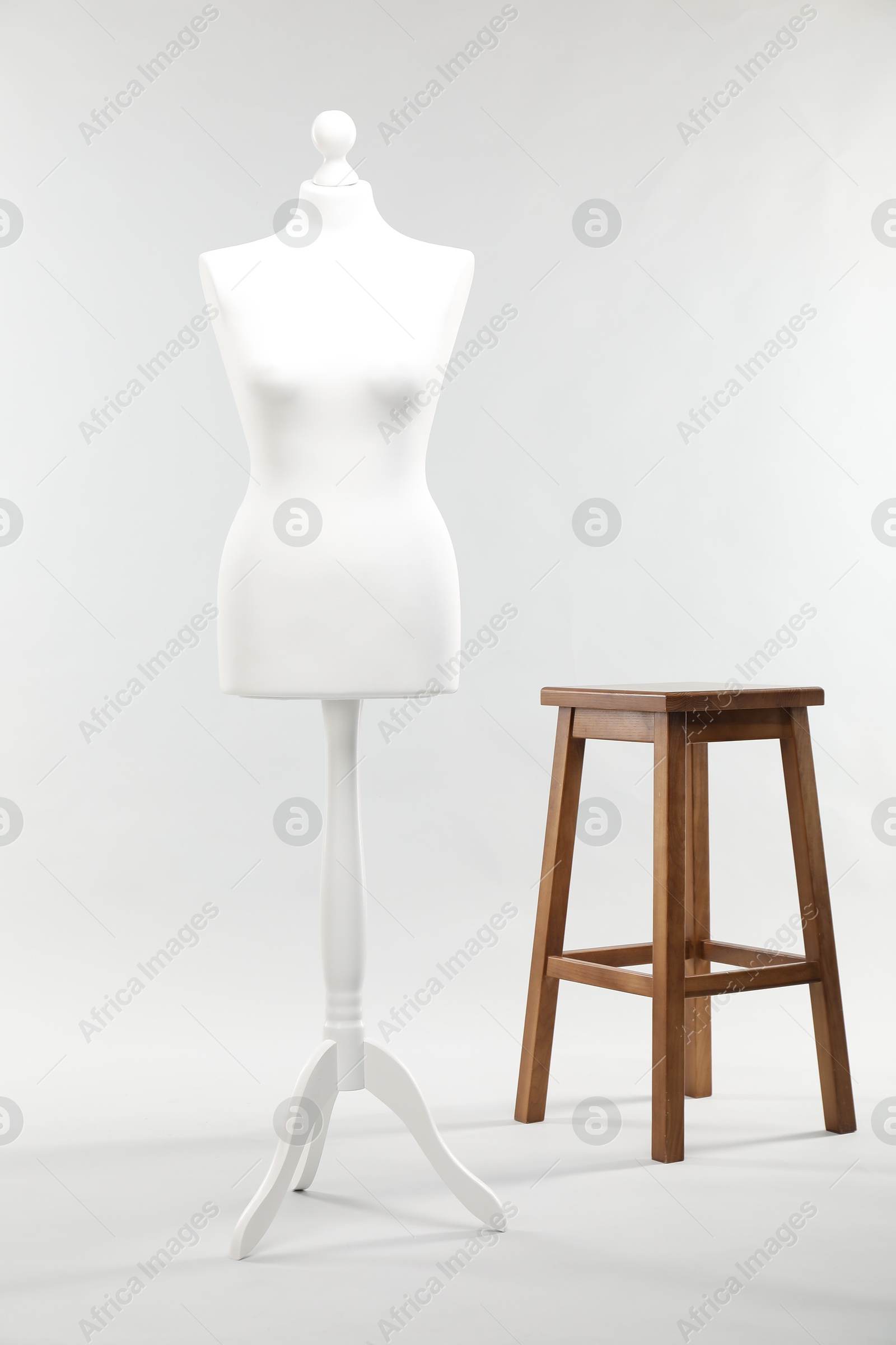 Photo of One female mannequin and stool on light background