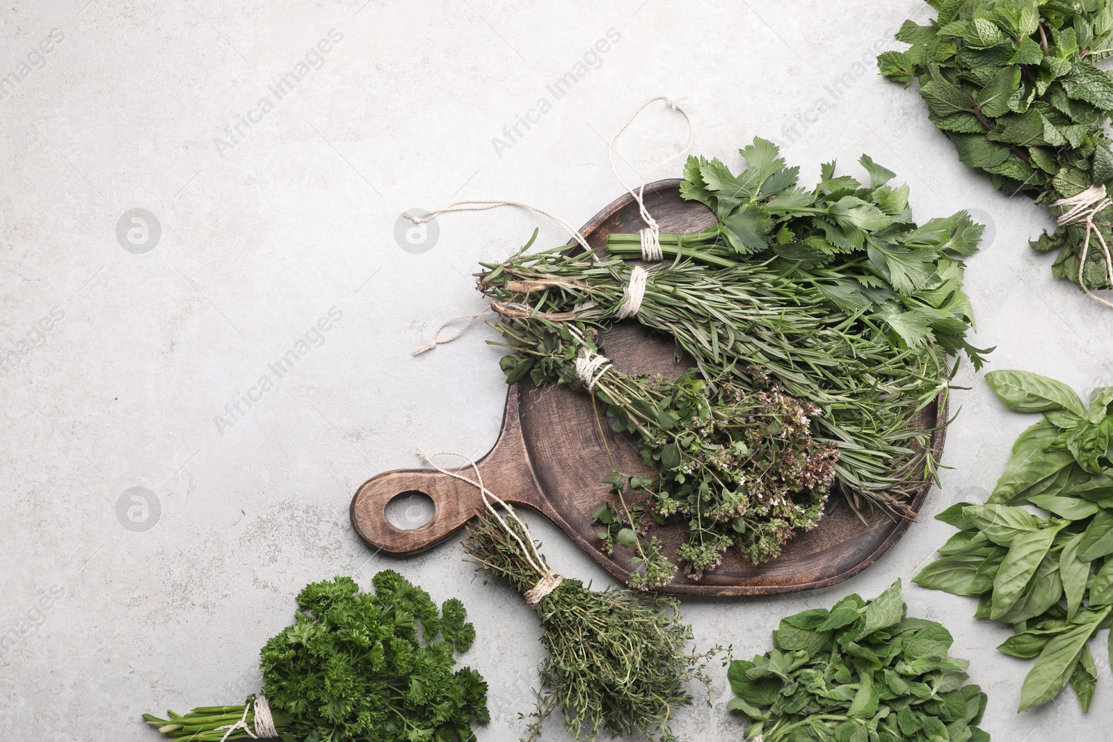 Photo of Different aromatic herbs on grey textured table, flat lay. Space for text