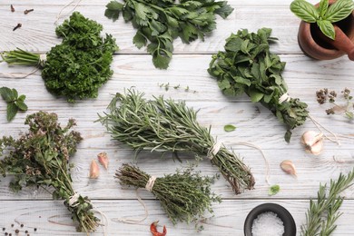 Photo of Different aromatic herbs on white wooden table, flat lay