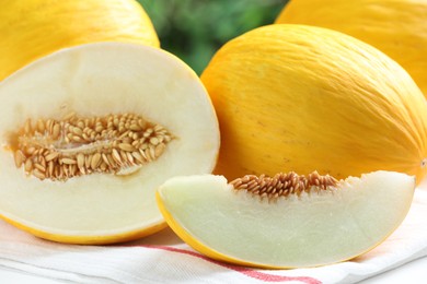 Photo of Fresh ripe melons on white table, closeup