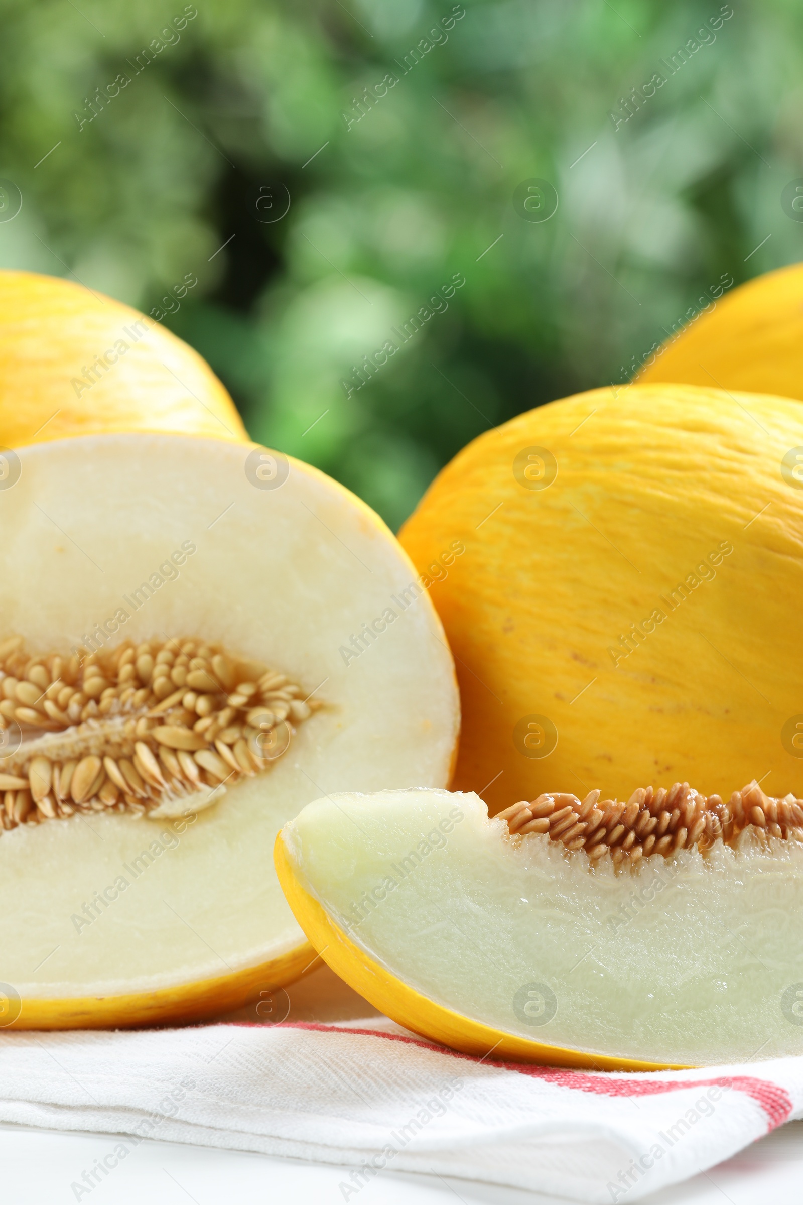 Photo of Fresh ripe melons on table outdoors, closeup