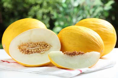 Fresh ripe melons on white table outdoors