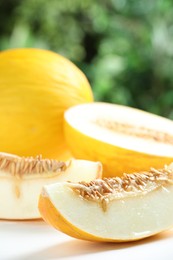 Fresh ripe melons on white table, closeup