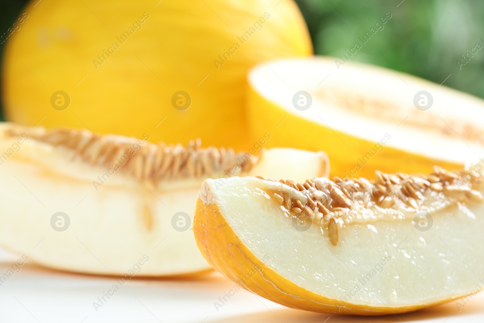 Photo of Fresh ripe melons on white table, closeup