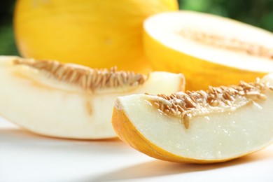 Photo of Fresh ripe melons on white table, closeup