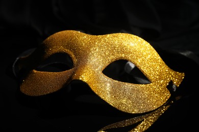 Beautiful golden carnival mask on black background, closeup