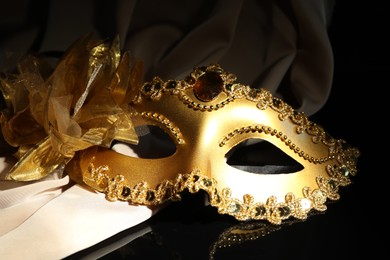 Beautiful golden carnival mask on black background, closeup