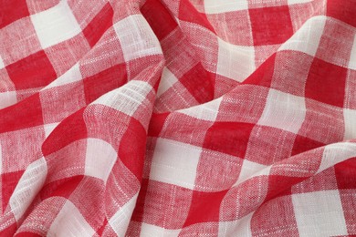 Photo of Crumpled tablecloth with checkered pattern as background, closeup