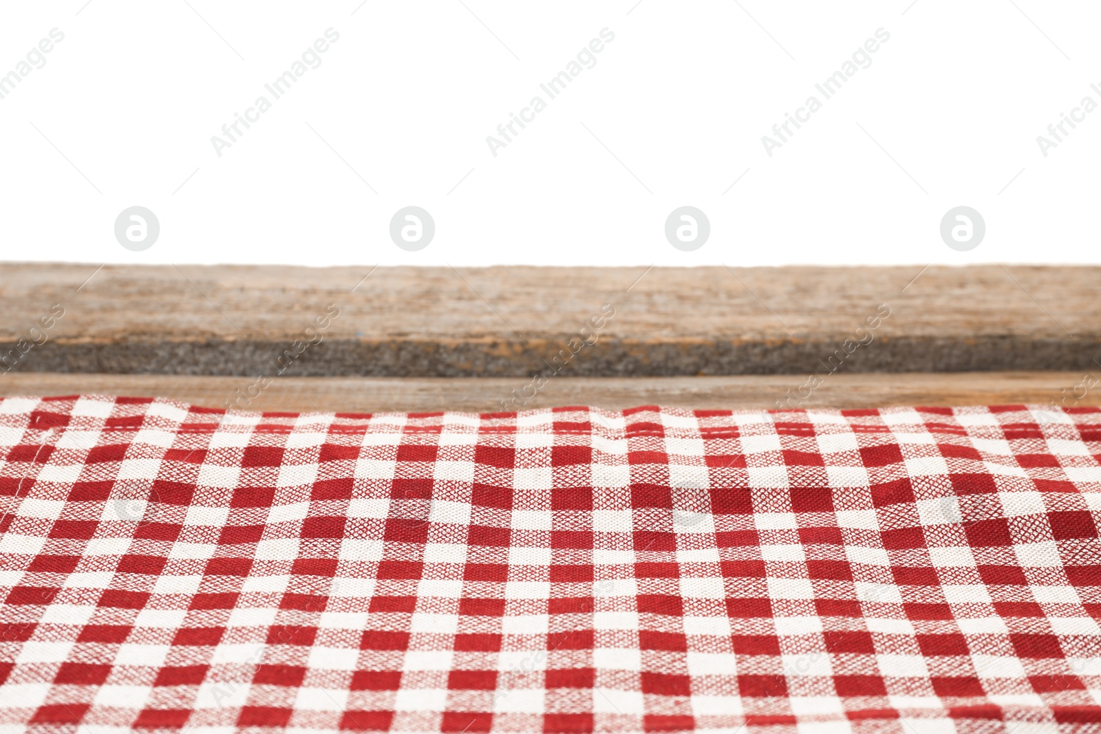 Photo of Tablecloth with checkered pattern on wooden table against white background