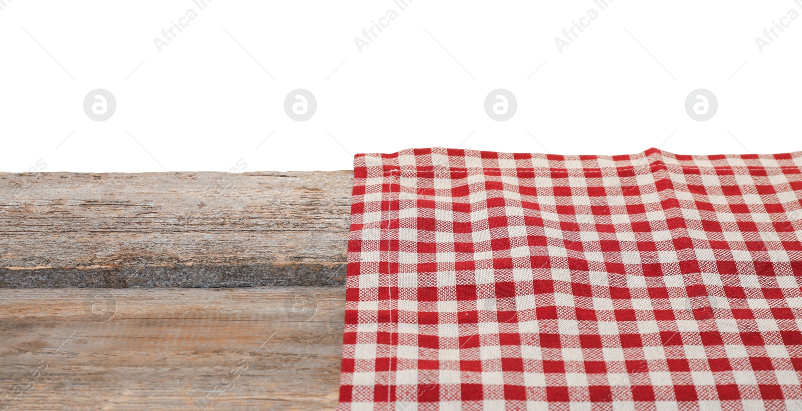 Photo of Tablecloth with checkered pattern on wooden table against white background