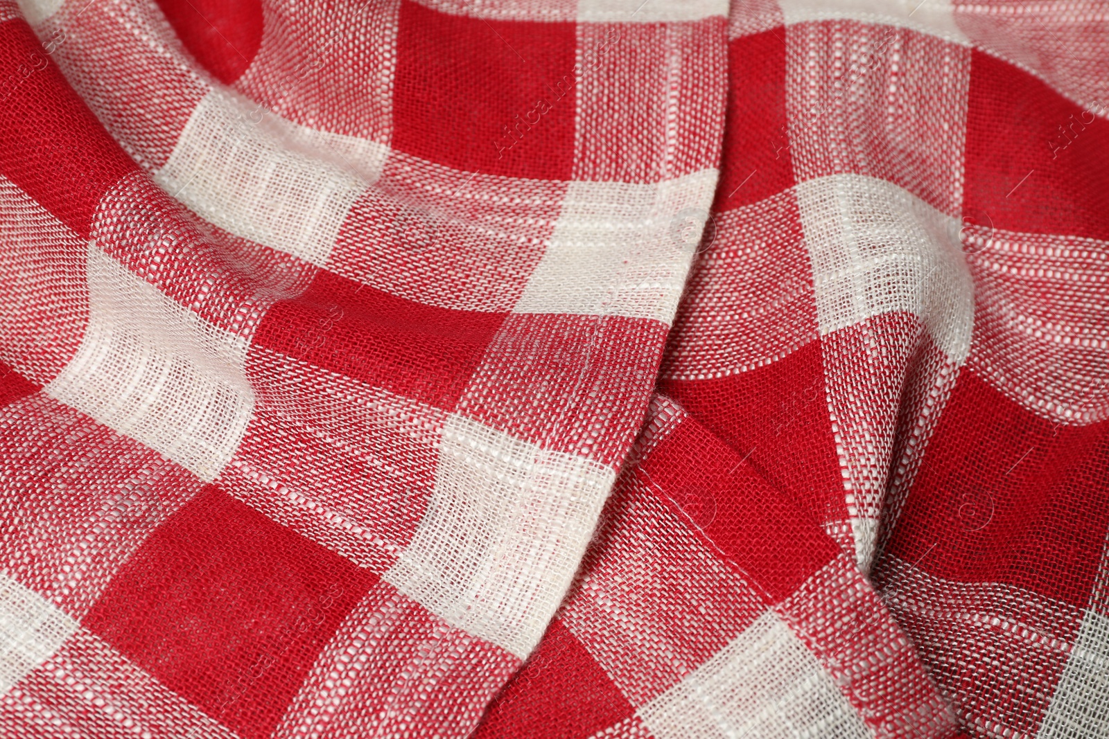 Photo of Crumpled tablecloth with checkered pattern as background, closeup