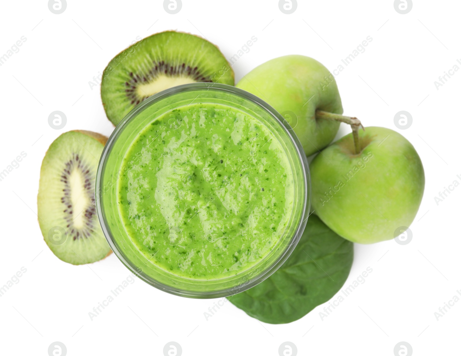 Photo of Tasty green smoothie in glass, spinach, apples and halves of kiwi isolated on white, top view