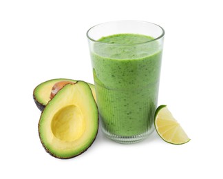 Photo of Tasty green smoothie in glass, avocado and lime isolated on white