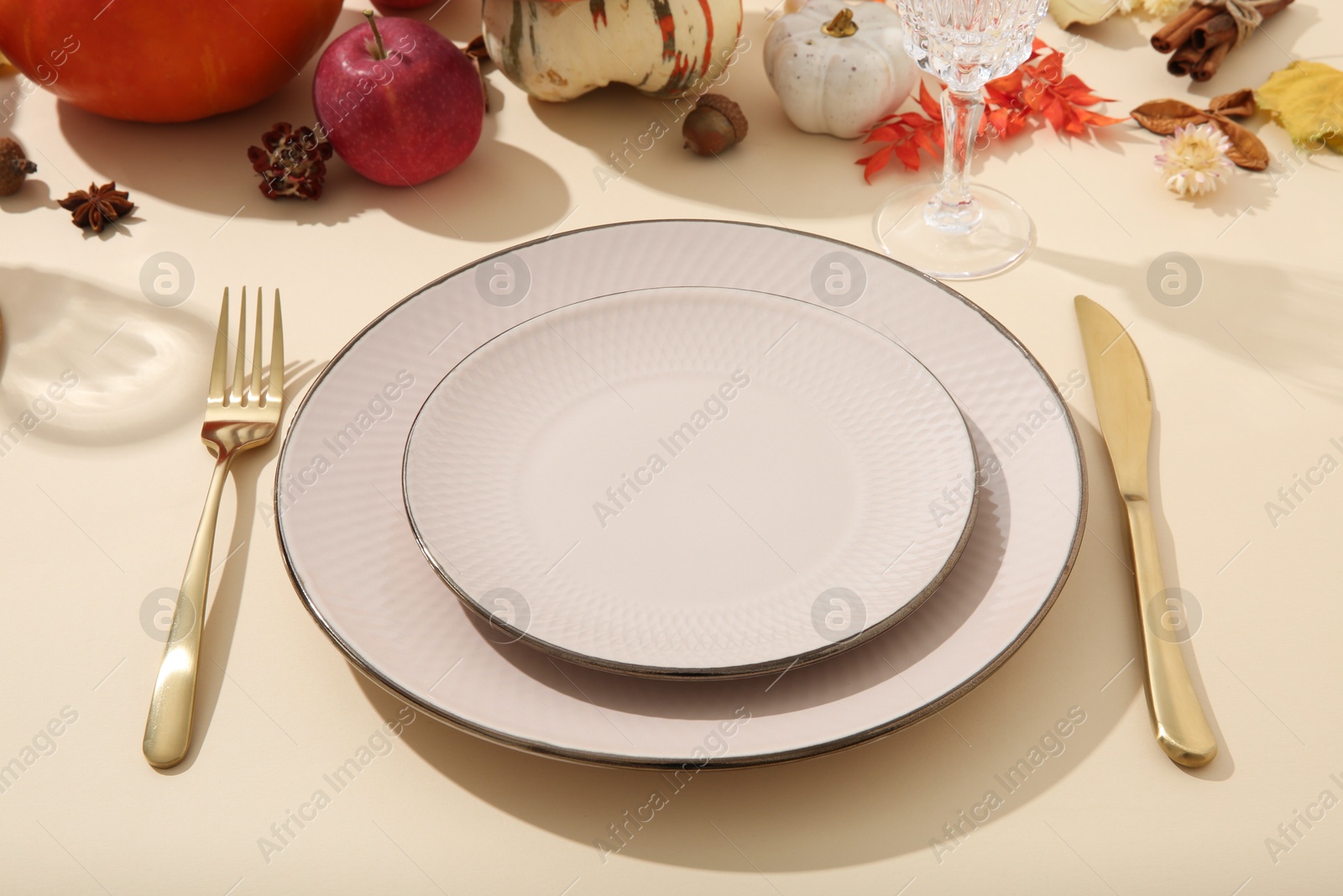 Photo of Beautiful table setting with autumn decor on beige background