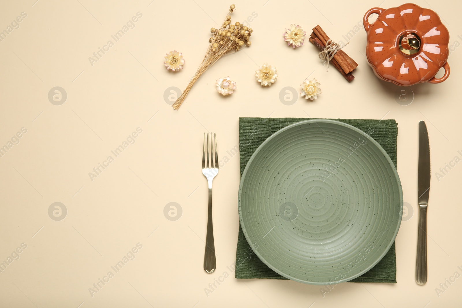 Photo of Beautiful table setting with autumn decor on beige background, flat lay. Space for text