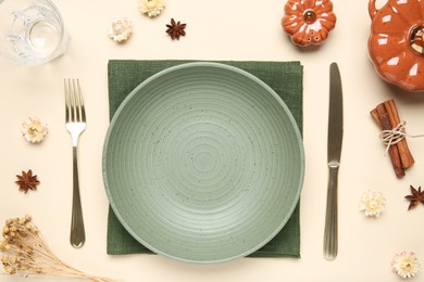 Photo of Beautiful table setting with autumn decor on beige background, flat lay